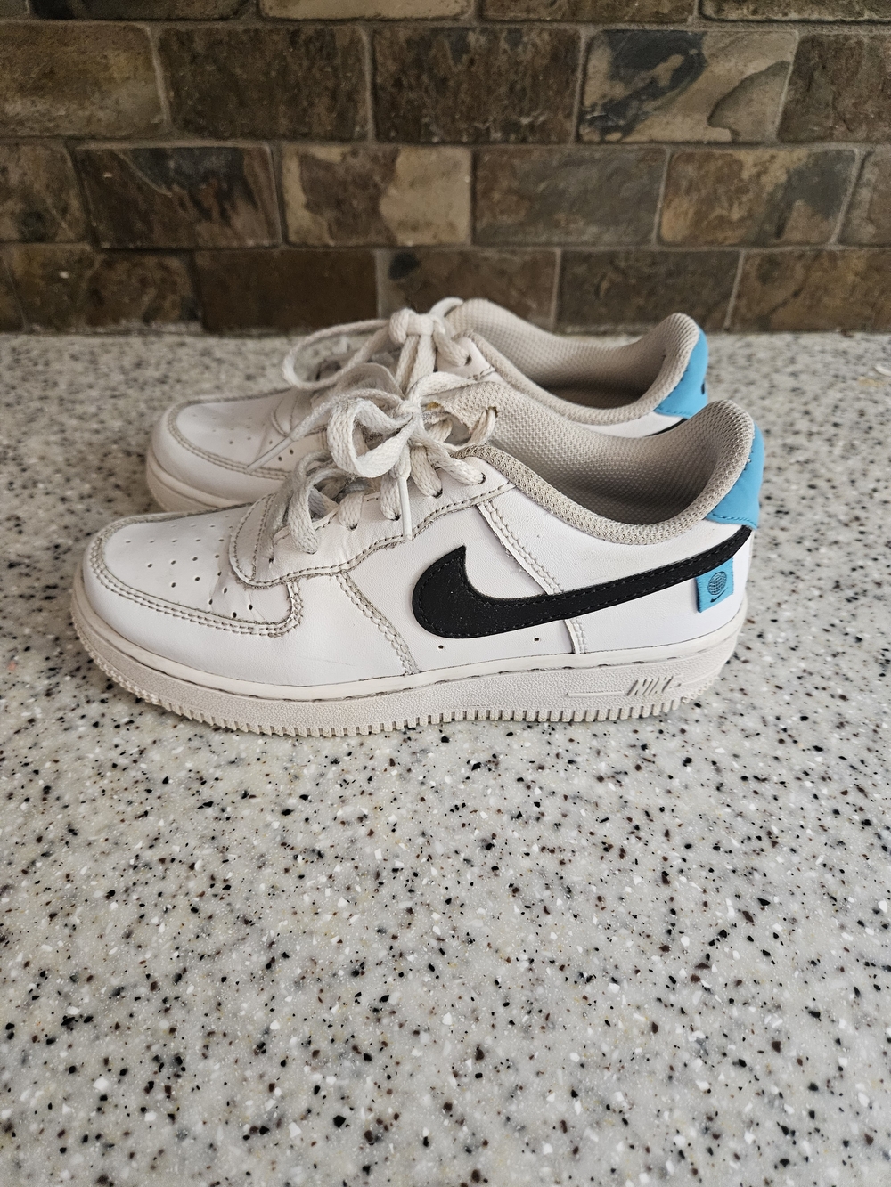 Nike Kids White Sneakers with Black Swoosh and Blue Heel